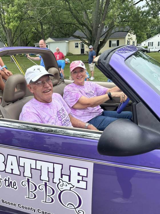 Couple cruising in the parade for a cause