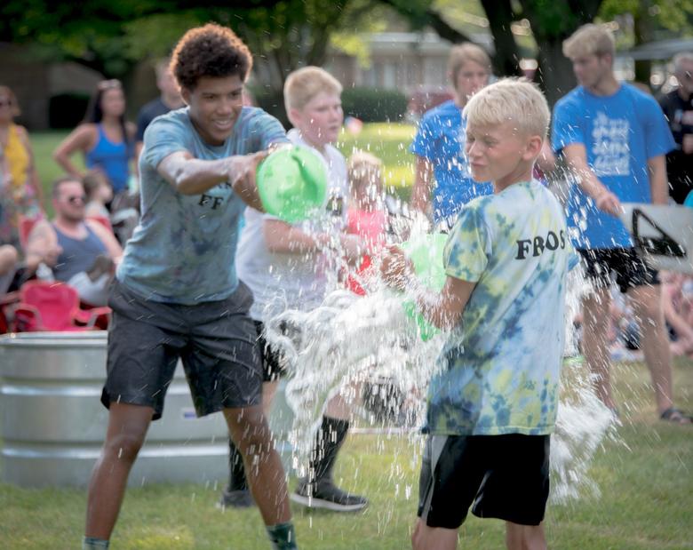 Kids dumping water at Almost Anything Goes