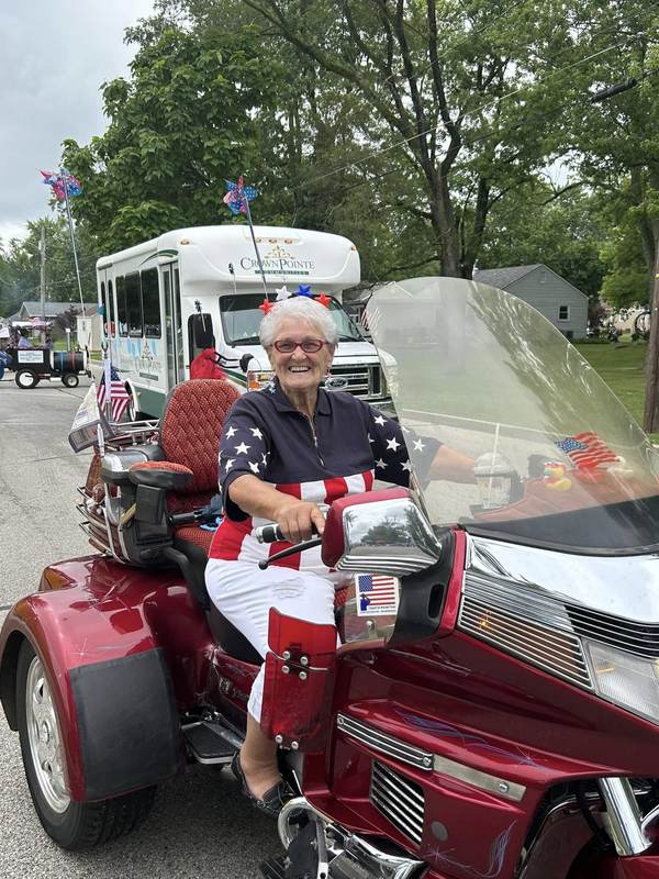 Woman riding a patriotic three wheeled motorcycle