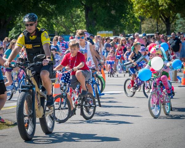 Children's bike parade with sheriff